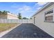 Backyard features concrete pavers and white fence along the side of the house at 5405 59Th N St, St Petersburg, FL 33709