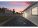 Backyard features concrete pavers and white fence along the side of the house at 5405 59Th N St, St Petersburg, FL 33709