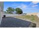 Large backyard features concrete pavers, a white fence, and some greenery at 5405 59Th N St, St Petersburg, FL 33709