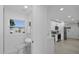 Partial view of bathroom leads to the kitchen with sleek modern design at 5405 59Th N St, St Petersburg, FL 33709