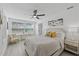 Bright bedroom features wood-look flooring, ceiling fan, and large windows at 5405 59Th N St, St Petersburg, FL 33709