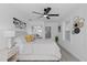 Bright bedroom features wood-look flooring, ceiling fan and ensuite bathroom with glass-enclosed shower at 5405 59Th N St, St Petersburg, FL 33709