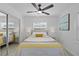 Bright bedroom features wood-look flooring, ceiling fan, and a mirrored closet at 5405 59Th N St, St Petersburg, FL 33709