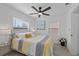 Bright bedroom features wood-look flooring, ceiling fan, and beach themed wall art at 5405 59Th N St, St Petersburg, FL 33709