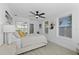 Bright bedroom features wood-look flooring, ceiling fan and ensuite bathroom with glass-enclosed shower at 5405 59Th N St, St Petersburg, FL 33709
