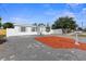 Charming single-story home with a well-maintained front yard and paver driveway at 5405 59Th N St, St Petersburg, FL 33709