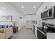 Well-lit open-concept kitchen featuring modern appliances and sleek design at 5405 59Th N St, St Petersburg, FL 33709