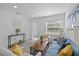 Cozy living room with a modern blue sofa, decorative pillows, and light-filled ambiance at 5405 59Th N St, St Petersburg, FL 33709