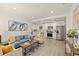 Spacious open-concept living room, kitchen combo with stainless appliances, and a light-colored floor at 5405 59Th N St, St Petersburg, FL 33709