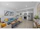 Open-concept living room flowing into a modern kitchen with white cabinets and stainless steel appliances at 5405 59Th N St, St Petersburg, FL 33709