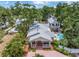 Beautiful home with lush landscaping, brick driveway, covered porch, and a sparkling swimming pool in the backyard at 546 26Th N Ave, St Petersburg, FL 33704