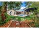 Spacious backyard with pool, stone walkway, patio, mature trees, and charming exterior home details at 546 26Th N Ave, St Petersburg, FL 33704