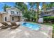 Beautiful backyard features a sparkling pool, lush landscaping, and ample space for outdoor relaxation and entertaining at 546 26Th N Ave, St Petersburg, FL 33704