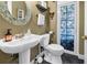 Charming half bathroom with pedestal sink and stained glass door at 546 26Th N Ave, St Petersburg, FL 33704