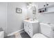 Bright bathroom featuring a vanity with storage, an oval mirror, and a toilet at 546 26Th N Ave, St Petersburg, FL 33704