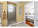 Bright en suite bathroom featuring a glass enclosed shower, window and bedroom access at 546 26Th N Ave, St Petersburg, FL 33704