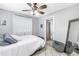 Cozy bedroom with natural light, soft textiles, a ceiling fan, and a view into an ensuite bathroom at 546 26Th N Ave, St Petersburg, FL 33704