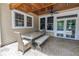 Charming covered patio featuring a dining table set, ceiling fan and views of the backyard oasis at 546 26Th N Ave, St Petersburg, FL 33704