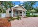 Charming home featuring a covered porch, well-maintained landscaping, and a brick driveway leading to the entrance at 546 26Th N Ave, St Petersburg, FL 33704
