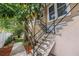 Exterior stairs leading to the home's entrance, complemented by lush landscaping and a well-maintained walkway at 546 26Th N Ave, St Petersburg, FL 33704