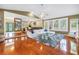 Spacious living room with wood floors, large windows, and a comfortable sectional at 546 26Th N Ave, St Petersburg, FL 33704
