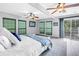Spacious bedroom featuring a sliding glass door to a balcony, ceiling fans, and green blinds at 546 26Th N Ave, St Petersburg, FL 33704