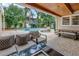 Inviting outdoor living space with a covered patio, modern furniture and a sparkling pool surrounded by tropical landscaping at 546 26Th N Ave, St Petersburg, FL 33704