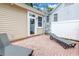 Enclosed patio with brick flooring, privacy fence and two sun loungers at 546 26Th N Ave, St Petersburg, FL 33704