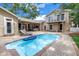 Private backyard oasis featuring a sparkling pool, ample patio space, and charming home exterior at 546 26Th N Ave, St Petersburg, FL 33704