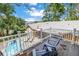 Backyard pool view from balcony, featuring trees, a yard, and lounge furniture at 546 26Th N Ave, St Petersburg, FL 33704