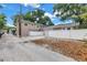 Rear view of the property with neat exteriors, a spacious parking area, and secure fencing at 546 26Th N Ave, St Petersburg, FL 33704