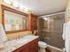 Bathroom featuring wood cabinets, granite countertop, and glass enclosed shower at 5729 Calais N Blvd # 6, St Petersburg, FL 33714