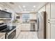 Updated kitchen featuring stainless steel appliances, granite countertops, and tiled flooring at 5729 Calais N Blvd # 6, St Petersburg, FL 33714