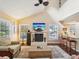Bright living room with fireplace, hardwood floors, and open floor plan to the kitchen at 5729 Calais N Blvd # 6, St Petersburg, FL 33714