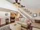 Cozy living room with hardwood floors, staircase, and adjacent dining area at 5729 Calais N Blvd # 6, St Petersburg, FL 33714