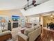 Sunlit living room featuring a fireplace, high ceilings, and wood flooring at 5729 Calais N Blvd # 6, St Petersburg, FL 33714