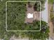 A close aerial view of the home's roof surrounded by trees and a glimpse of the street at 701 59Th Ne Ave, St Petersburg, FL 33703