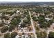 An aerial view of a residential area with tree-lined streets, showcasing homes, and the distant cityscape at 701 59Th Ne Ave, St Petersburg, FL 33703