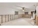 Partially renovated living area with concrete floors, ceiling fan, and exposed wall framing at 701 59Th Ne Ave, St Petersburg, FL 33703