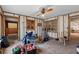 Spacious living area with wood-look floors, ceiling fan, and natural light from windows at 701 59Th Ne Ave, St Petersburg, FL 33703