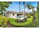 Gorgeous backyard featuring a private pool, lush landscaping, and a spacious patio area for outdoor relaxation at 7032 Pelican Island Dr, Tampa, FL 33634