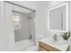 Modern bathroom featuring sleek fixtures, an illuminated mirror, and a shower with bathtub combination at 7032 Pelican Island Dr, Tampa, FL 33634