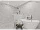 This updated bathroom features marble walls, a soaking tub and walk-in shower at 7032 Pelican Island Dr, Tampa, FL 33634