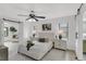 Charming primary bedroom features a ceiling fan, hard surface flooring, and access to an ensuite bathroom at 7032 Pelican Island Dr, Tampa, FL 33634