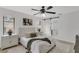Charming primary bedroom features a decorative ceiling fan and a sliding door to the ensuite bathroom at 7032 Pelican Island Dr, Tampa, FL 33634