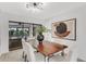 Chic dining area featuring modern art and sliding doors to an outdoor pool at 7032 Pelican Island Dr, Tampa, FL 33634