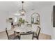 Bright dining room with a view of the kitchen, decorated with a marble table, stylish seating, and modern decor at 7032 Pelican Island Dr, Tampa, FL 33634