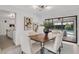 Dining room featuring a wood table, modern art, and sliding doors at 7032 Pelican Island Dr, Tampa, FL 33634