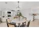 Open-concept dining area with modern light fixture, leading into a living room and kitchen, ideal for entertaining at 7032 Pelican Island Dr, Tampa, FL 33634