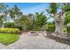 Inviting backyard fire pit area with stone pavers, perfect for outdoor entertaining and relaxing evenings at 7032 Pelican Island Dr, Tampa, FL 33634